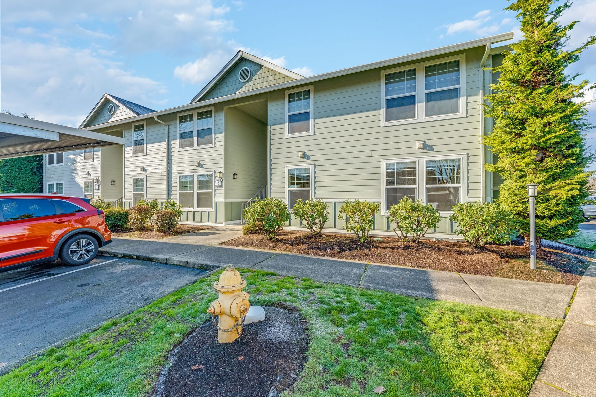 Exterior of apartment building with fire hydrant in the foreground.