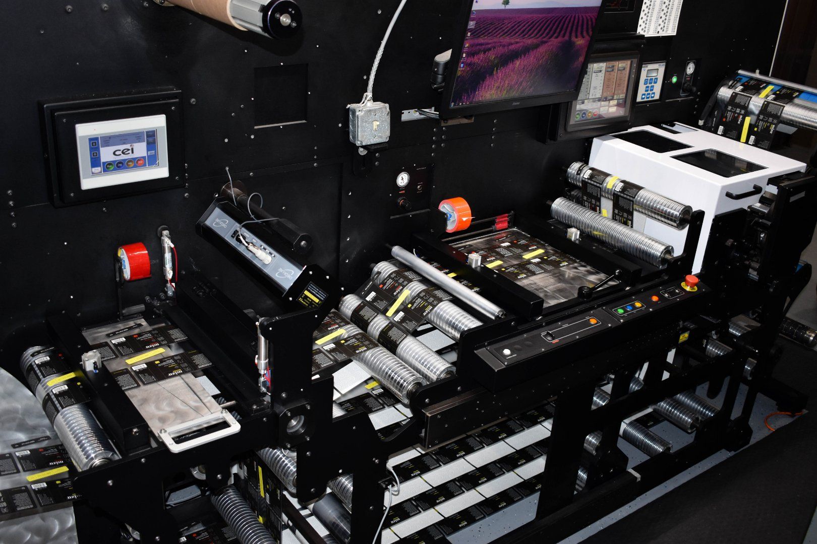 An order of labels with several high decoration elements being given a final review on an inspection machine