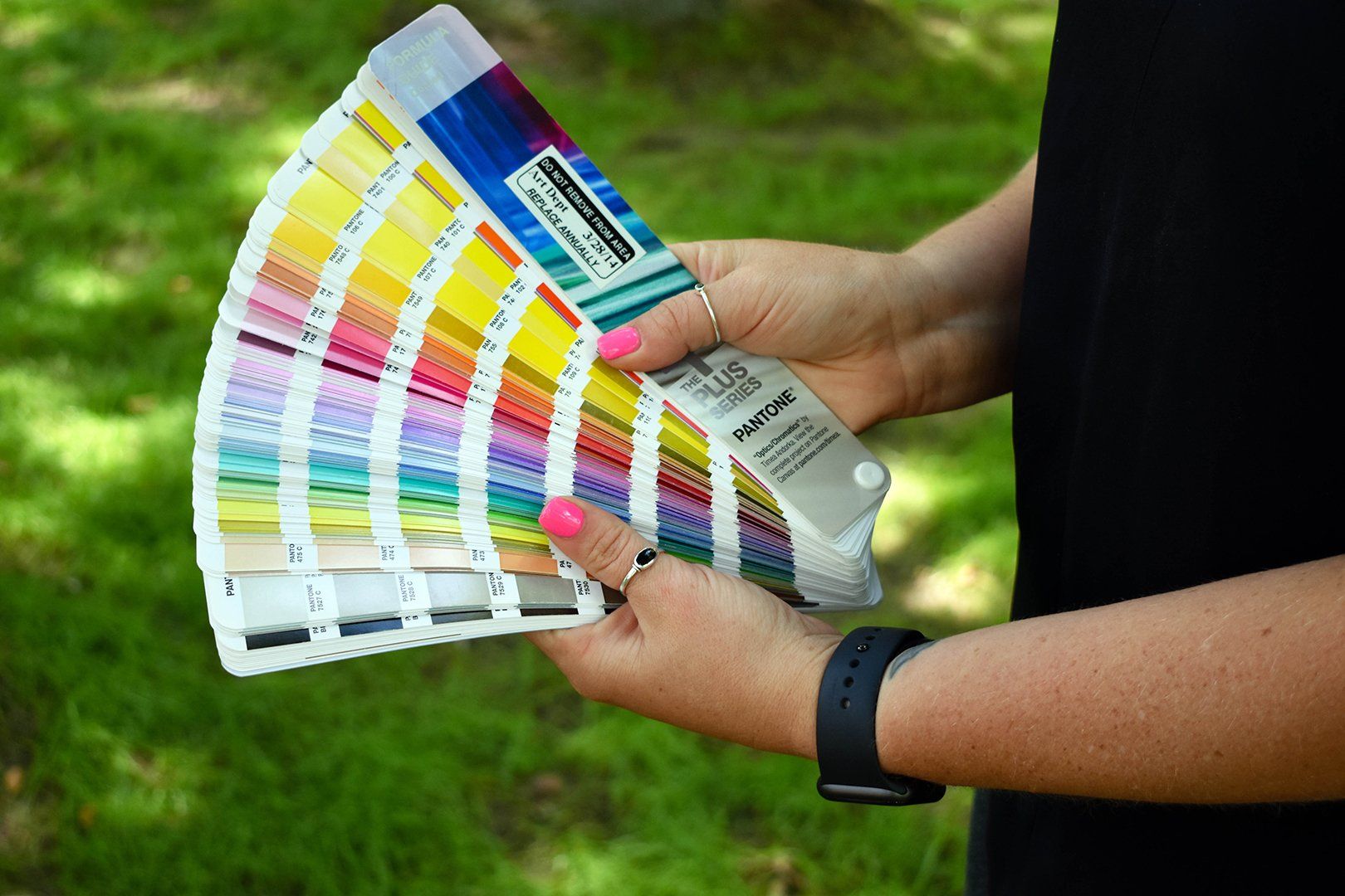 Person holding Pantone color book fanned out