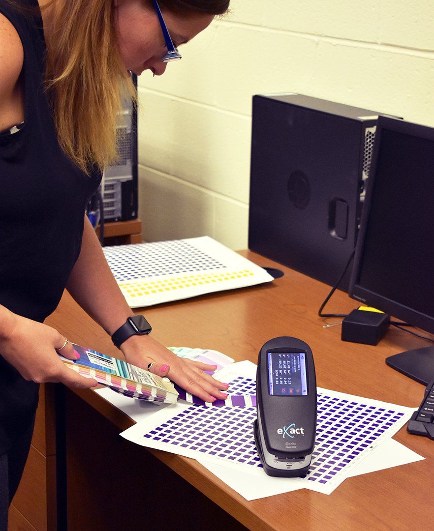 An artist using a spectrophotometer to inspect colors