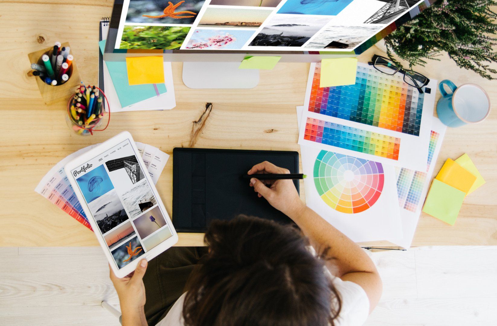Designer working at desk with color swatches
