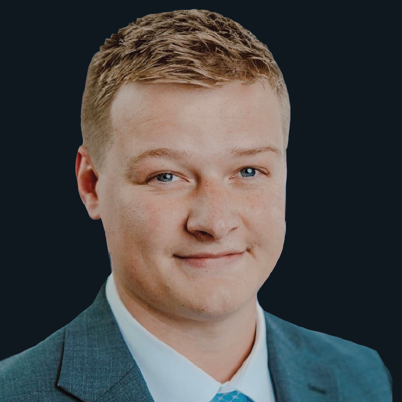 A man in a suit and tie is smiling for the camera.