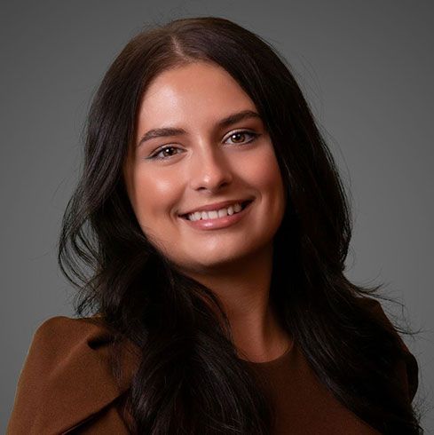 A man in a suit and tie is smiling for the camera