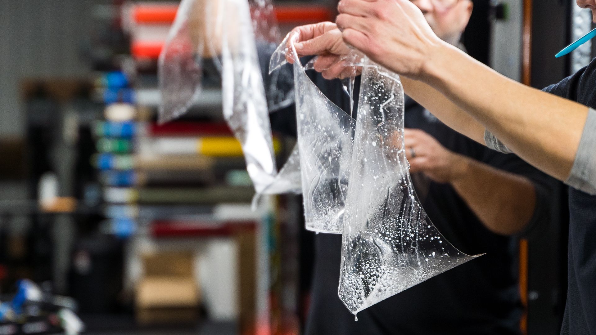 a person is holding a clear plastic wrap in their hands