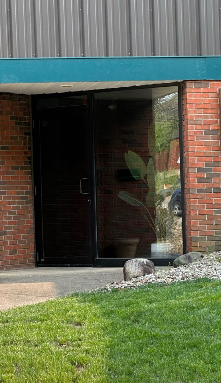 a brick building with a plant in front of it