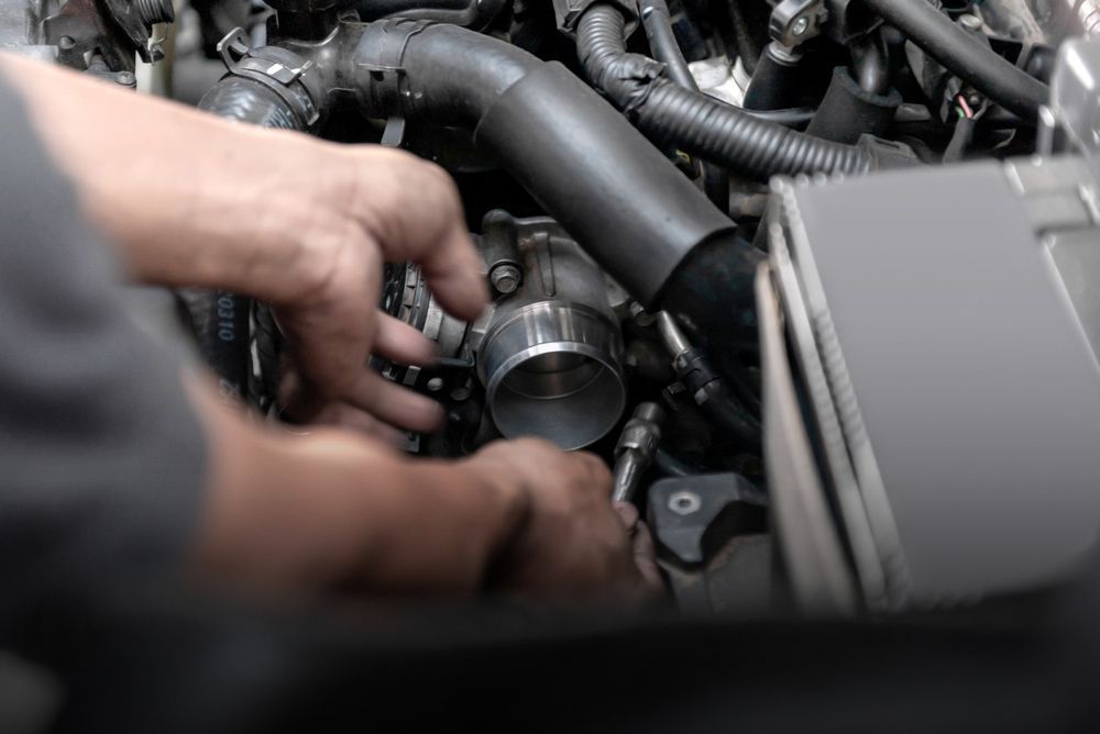 Man is Working on a Car Engine in a Garage — Oaks Automotive Pty Ltd in Oak Flats, NSW