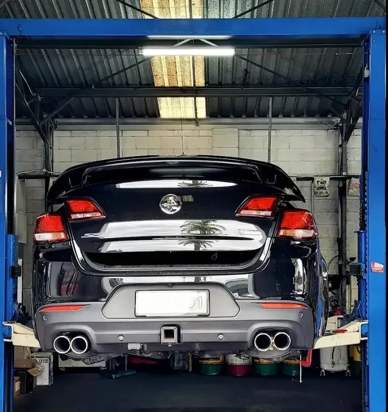 Car Hoisted Up — Oaks Automotive Pty Ltd in Oak Flats, NSW