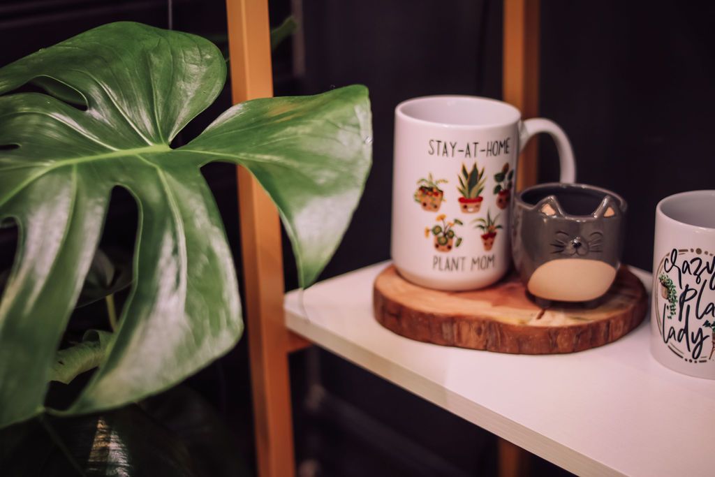 A shelf with mugs, including one with 