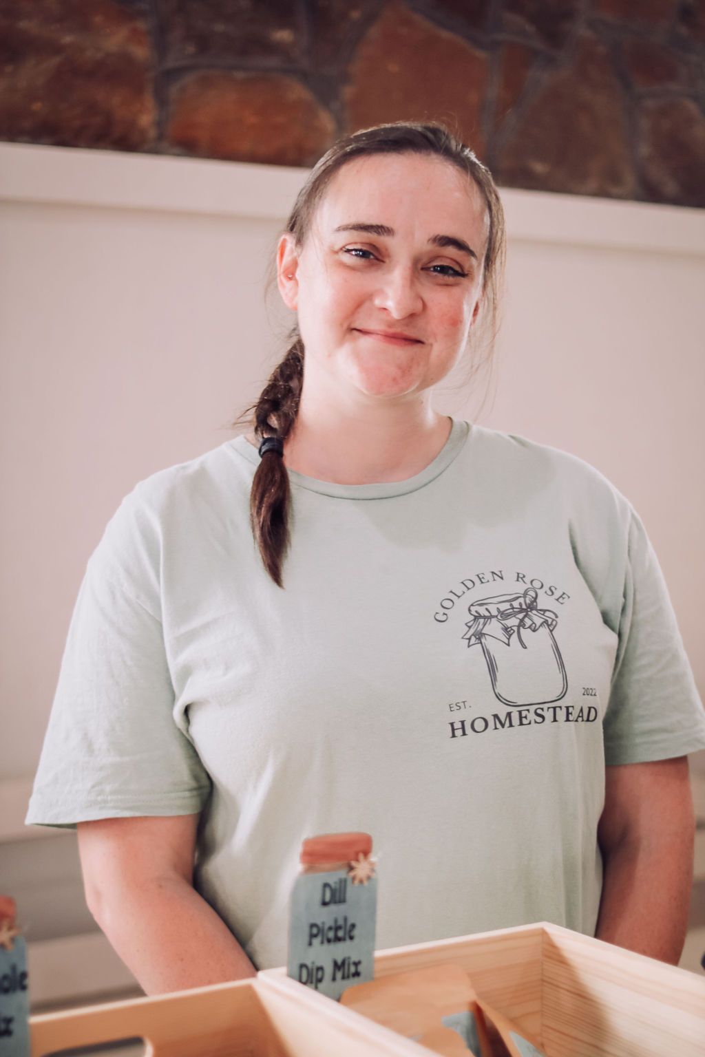 Woman smiling, wearing a light blue 