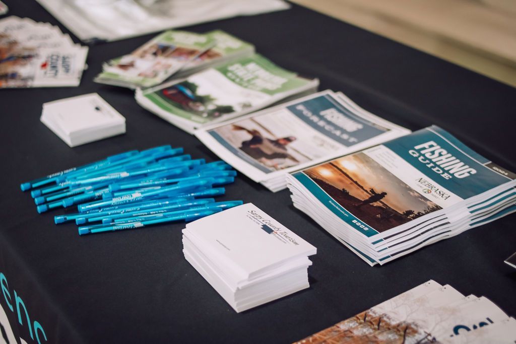 Table display of pamphlets and promotional materials in various colors.