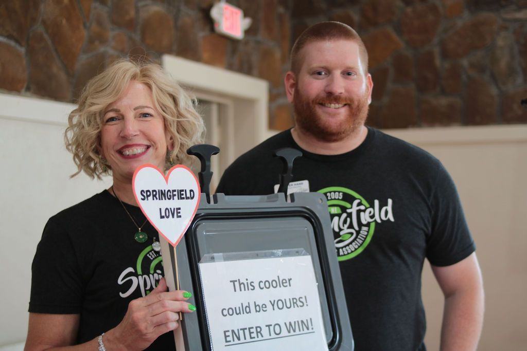Woman and man holding sign 