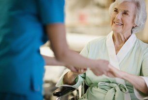 Old woman hold hands of a nurse
