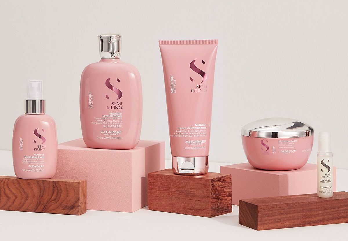 A group of pink bottles sitting on top of wooden blocks.
