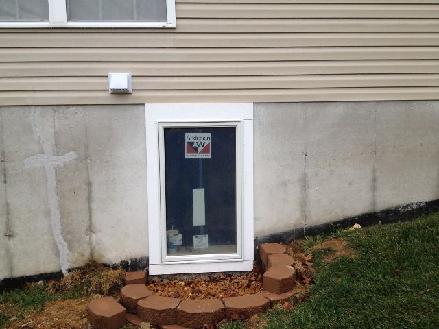 A row of window wells on the side of a house.
