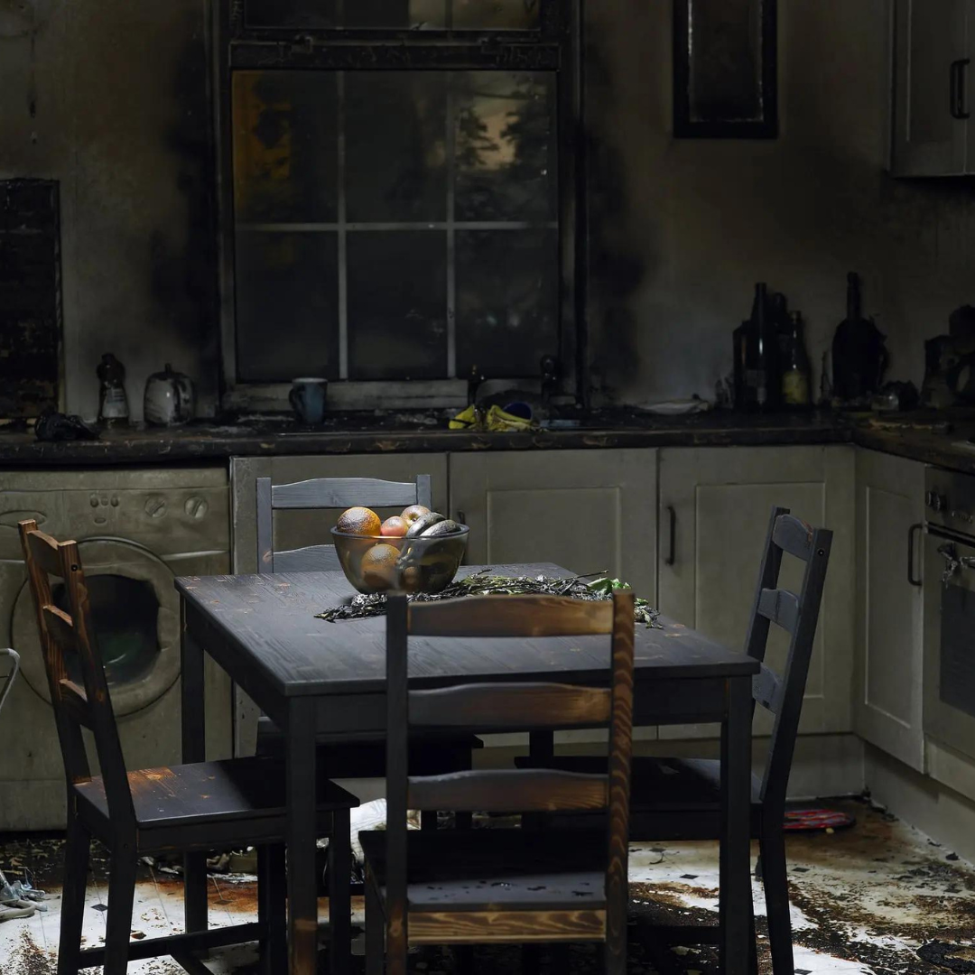 Image of a kitchen/dining room with fire/smoke damage.