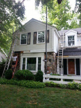 Repairman Fixing The Exterior Of The House — Warrenville, IL — D-S Exteriors Inc
