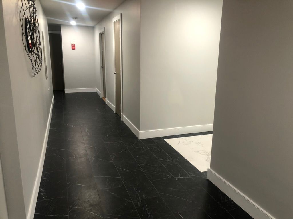 A long hallway with a clock on the wall