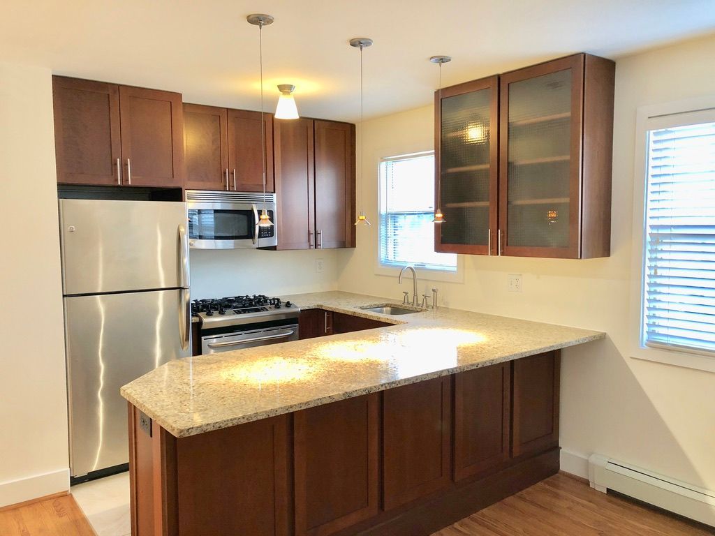 A kitchen with stainless steel appliances and wooden cabinets