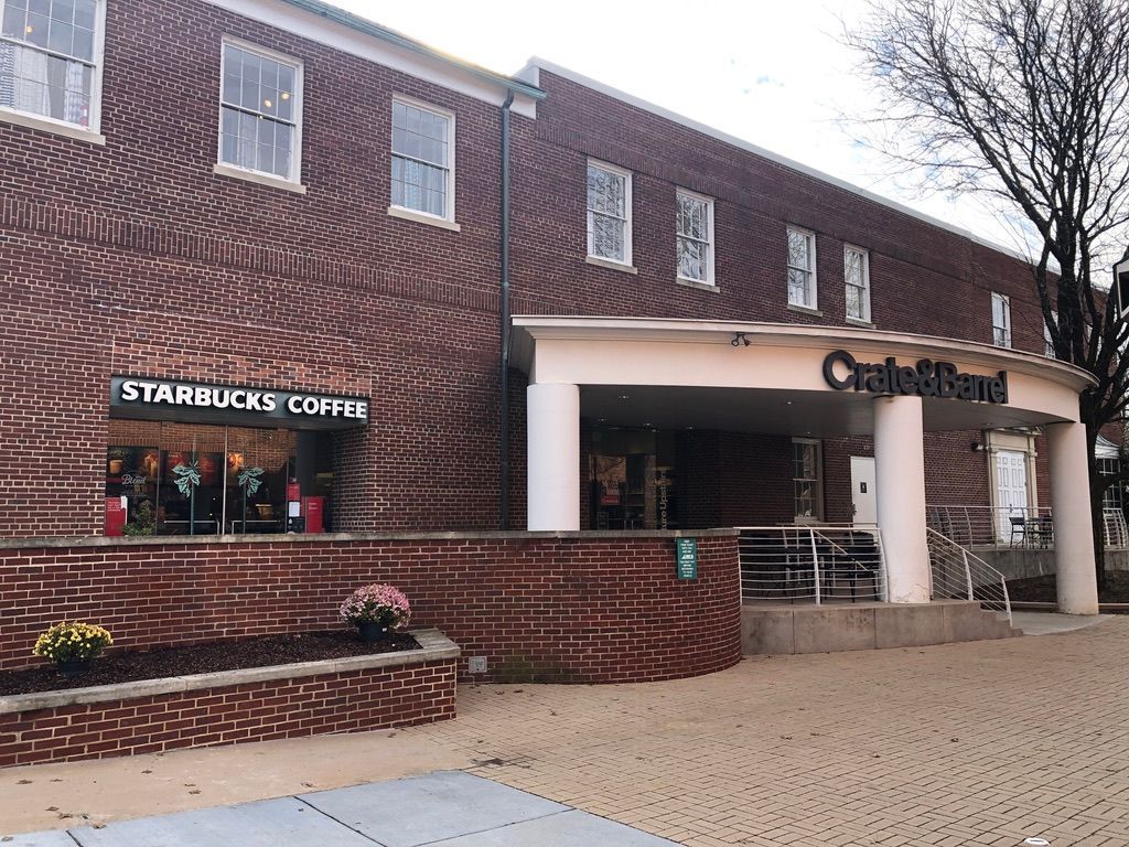A brick building with a sign that says starbucks coffee on it.
