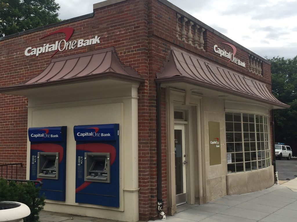 A capital one bank building with two atm machines outside