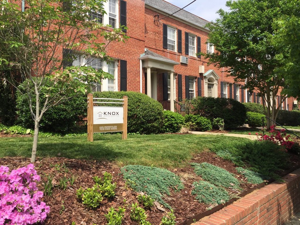 A large brick building with a sign in front of it.