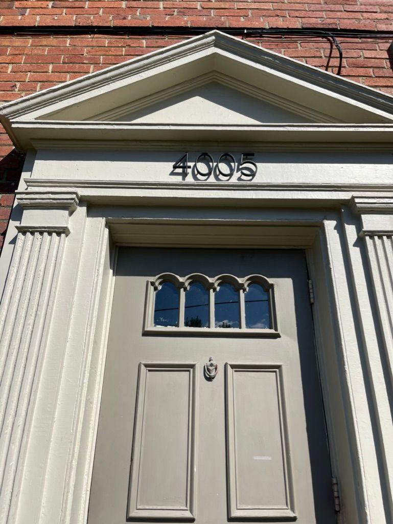 A door with the number 4005 on it is on a brick building.
