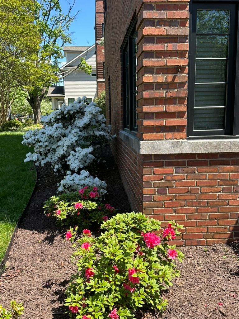 A brick building with flowers in front of it