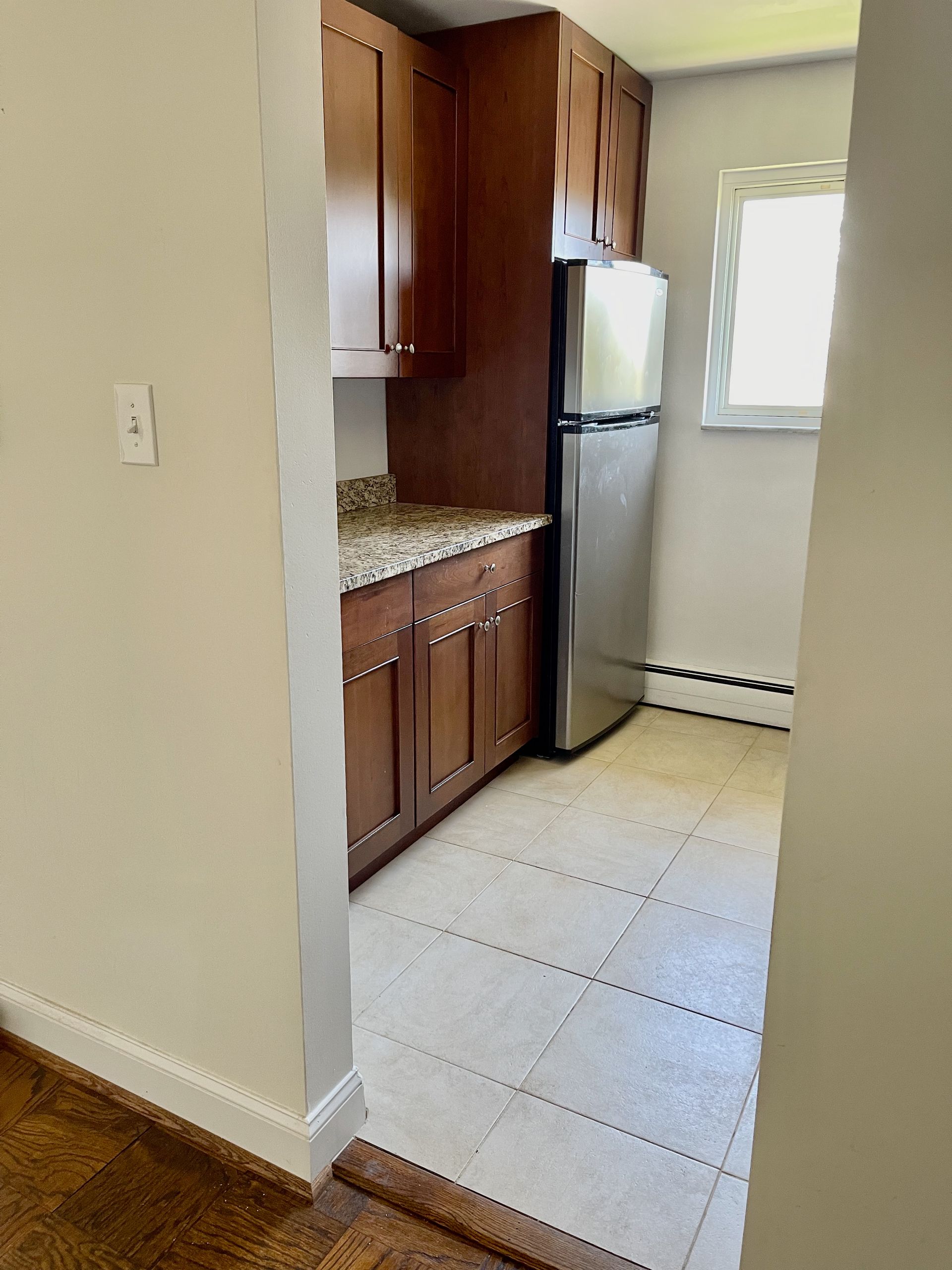 A kitchen with stainless steel appliances and wooden cabinets