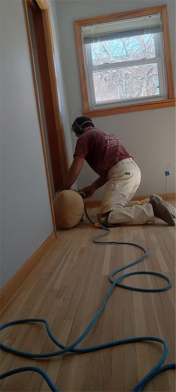 A man is kneeling on the floor in a room.