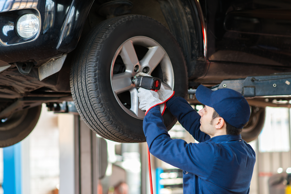 Mechanic Putting Back a Brand-new Tire — Saint Paul, Minnesota — Xpress Tire and Auto Repair
