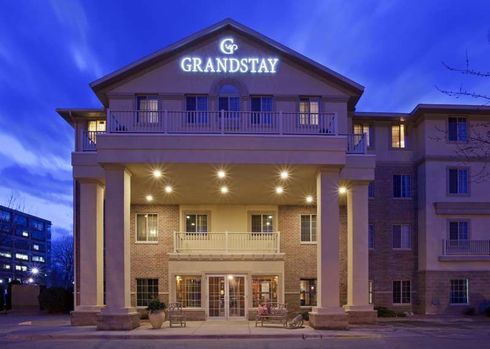 A large building with a sign that says grandstay on it