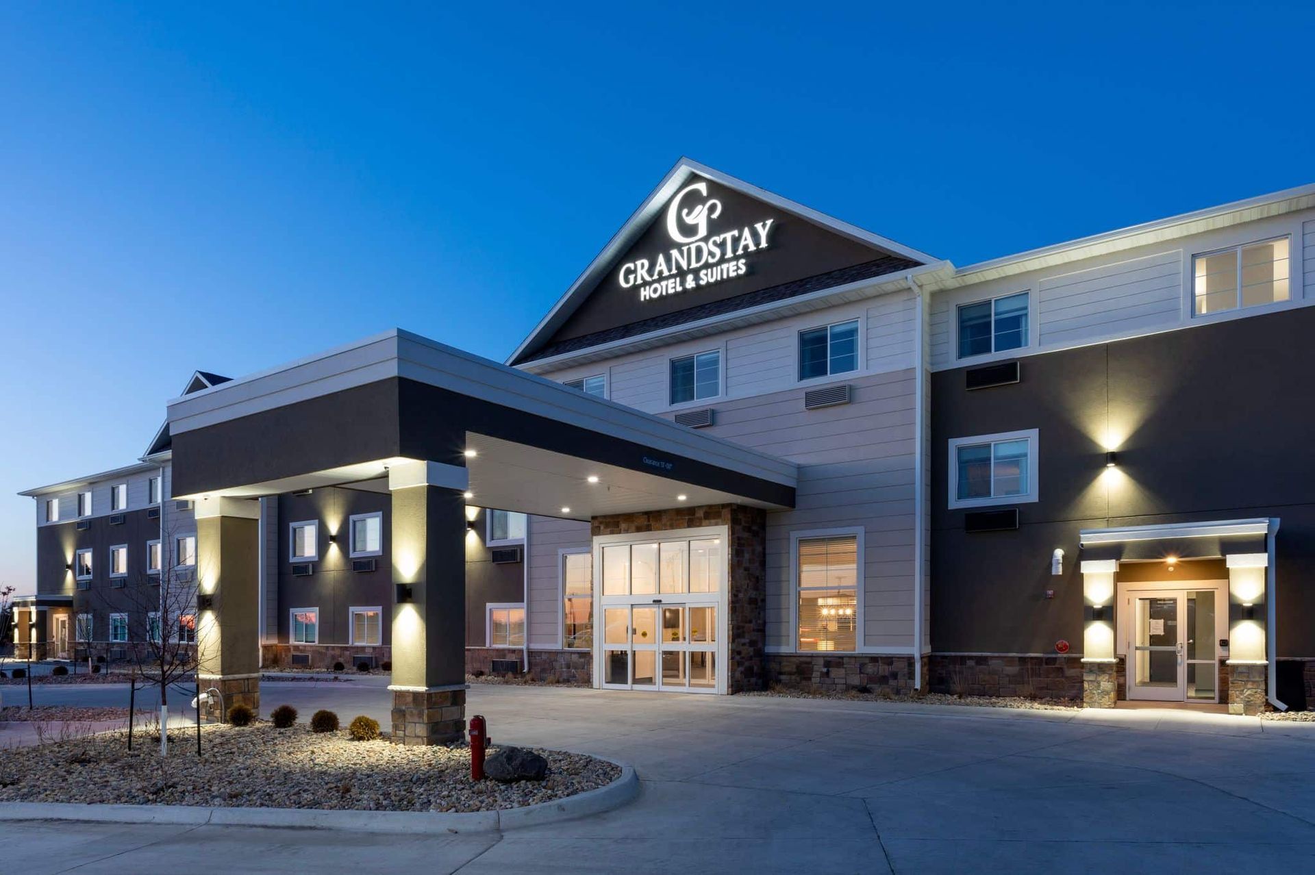 A large hotel with a lot of windows is lit up at night.