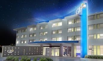 A large building with a lot of windows is lit up at night.