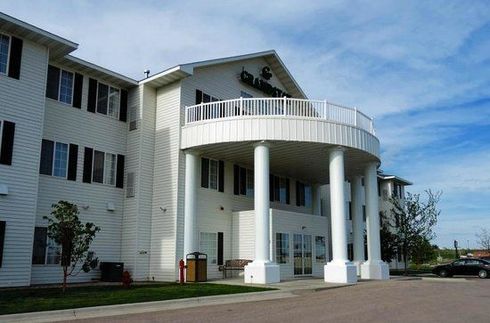 A large white building with a balcony and columns