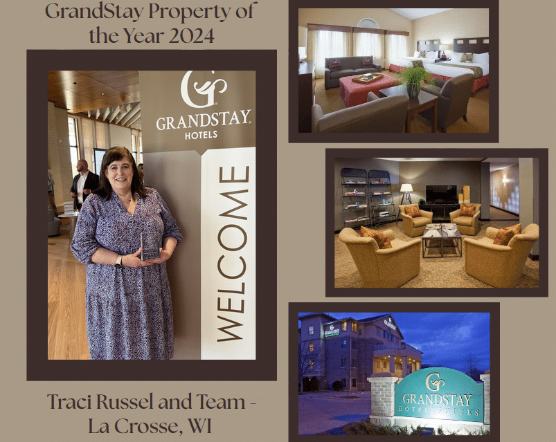 Woman holding award in GrandStay Hotel, La Crosse, WI, celebrating Property of the Year 2024.