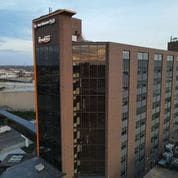 An aerial view of a large brick building with a lot of windows.