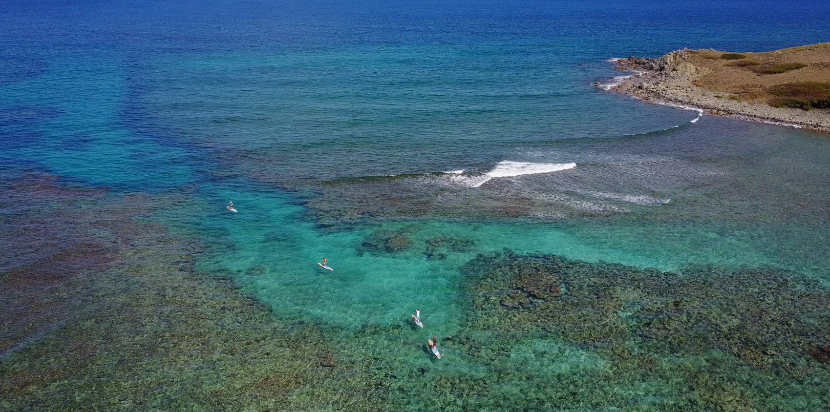 Two paddle boards passing the channel by Pinel island