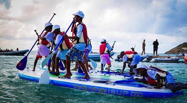 Kids playing onto a giant paddle board during 