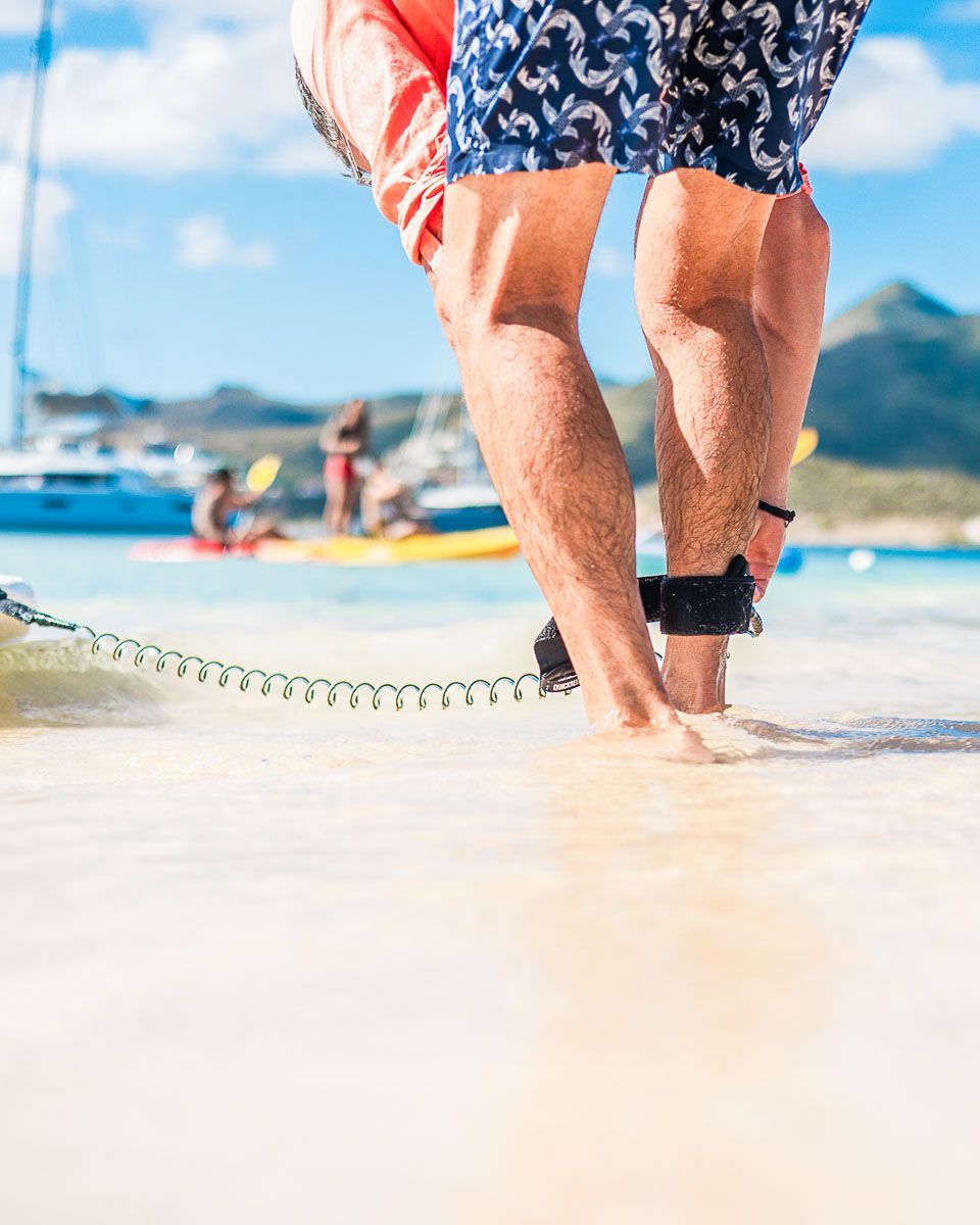 A red kayak with a black seat that says RTM on it