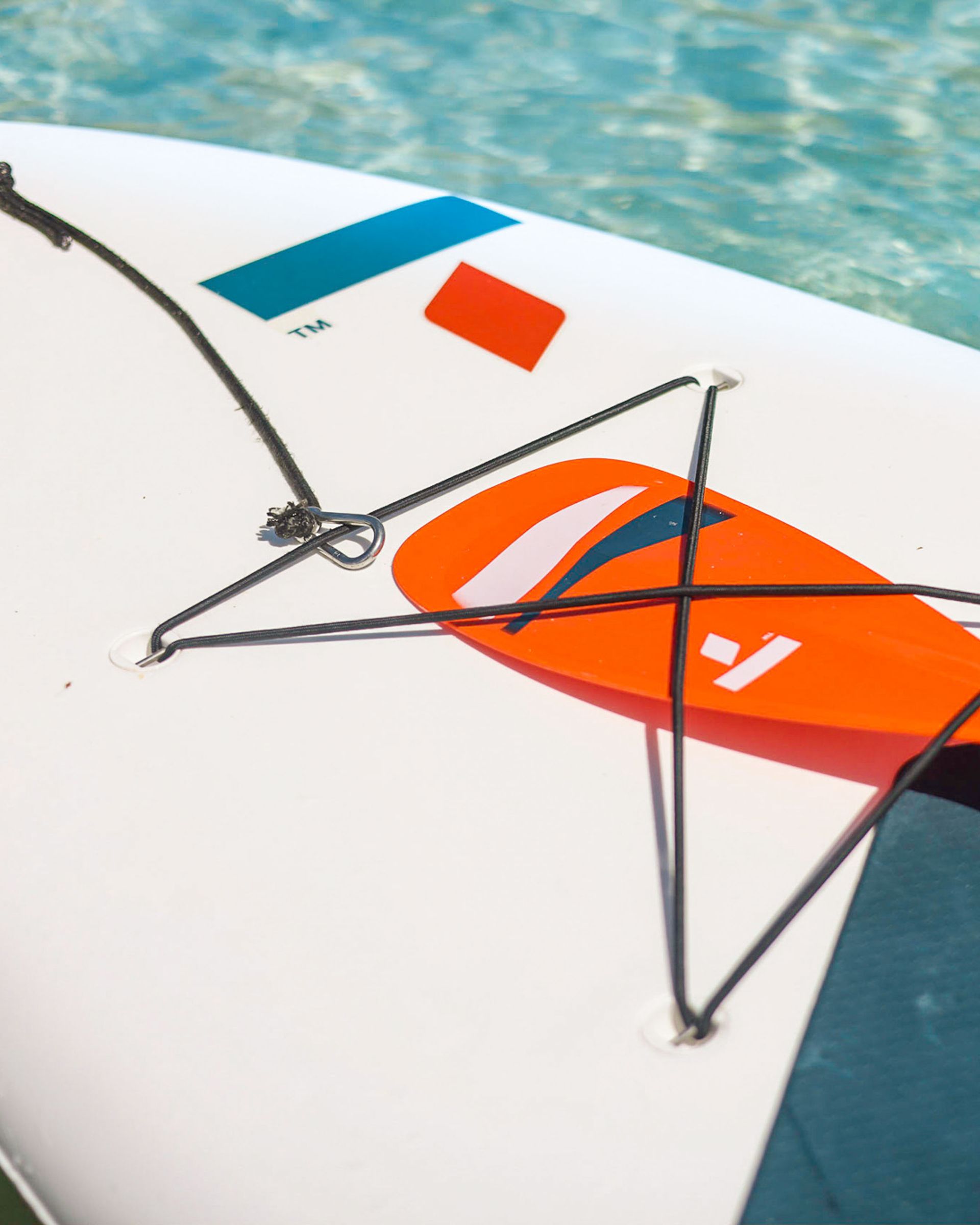 A group of people are paddling kayaks in the water.