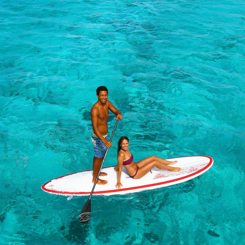 A couple having fun on a paddle board