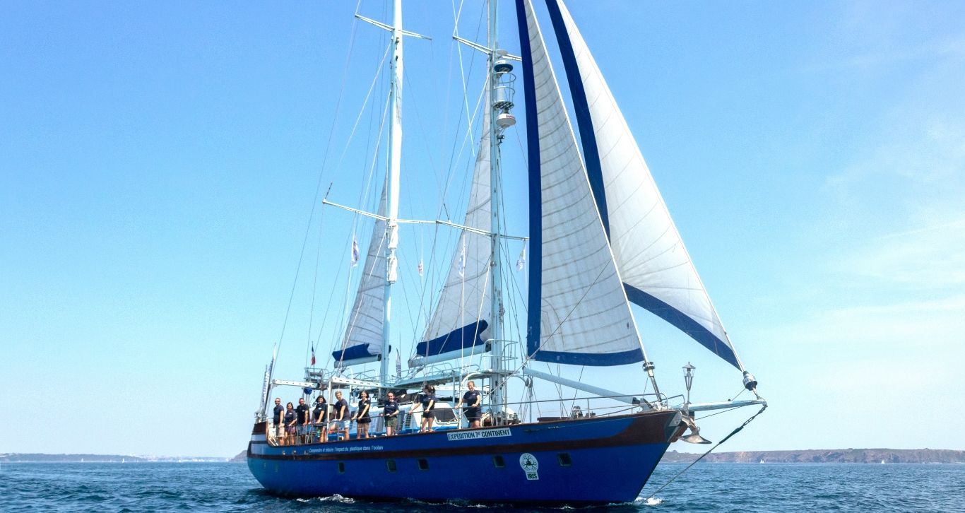A sailboat is floating on top of a body of water.