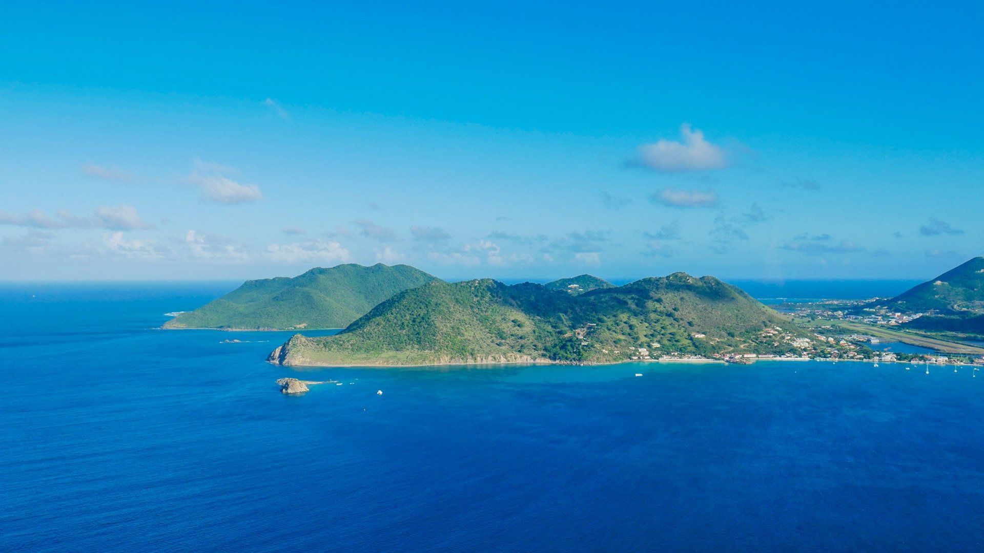 An aerial view of a small island in the middle of the ocean.