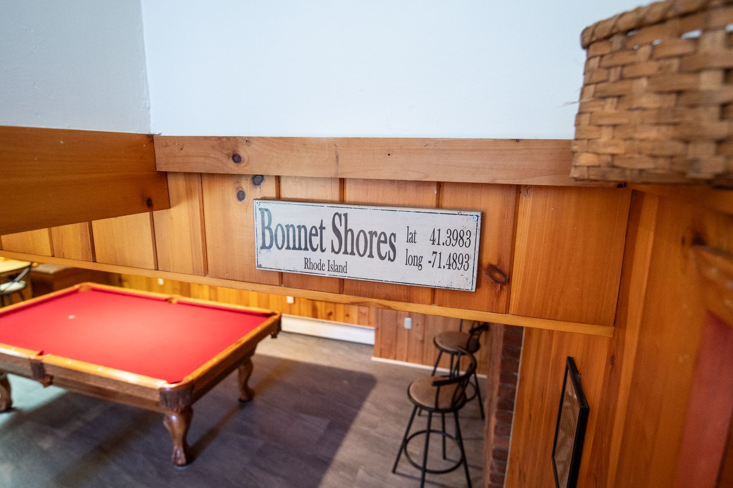 A pool table in a room with a sign that says bonnet shores