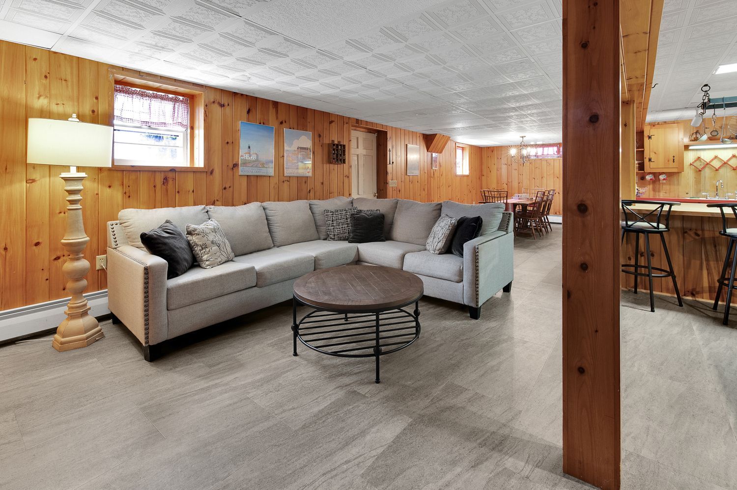 A living room with a large sectional couch and a coffee table.