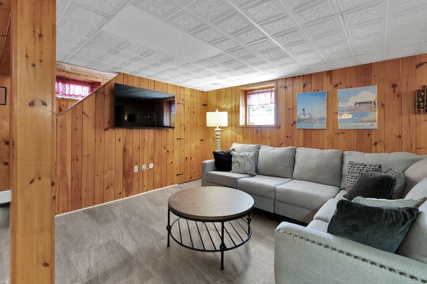 A living room with a couch , coffee table , and television.
