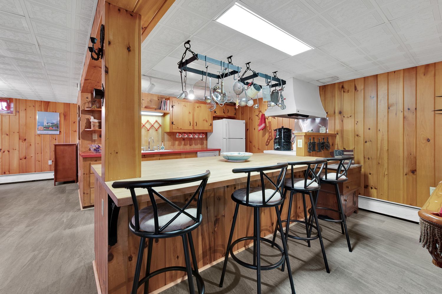 A kitchen with a bar and stools in it