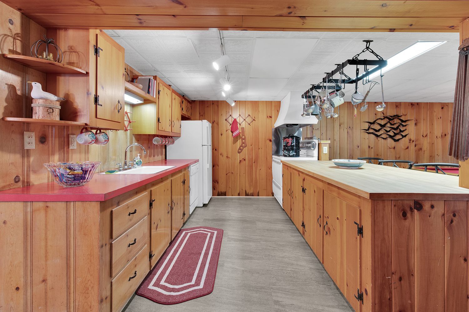 A kitchen with wooden cabinets and a refrigerator.