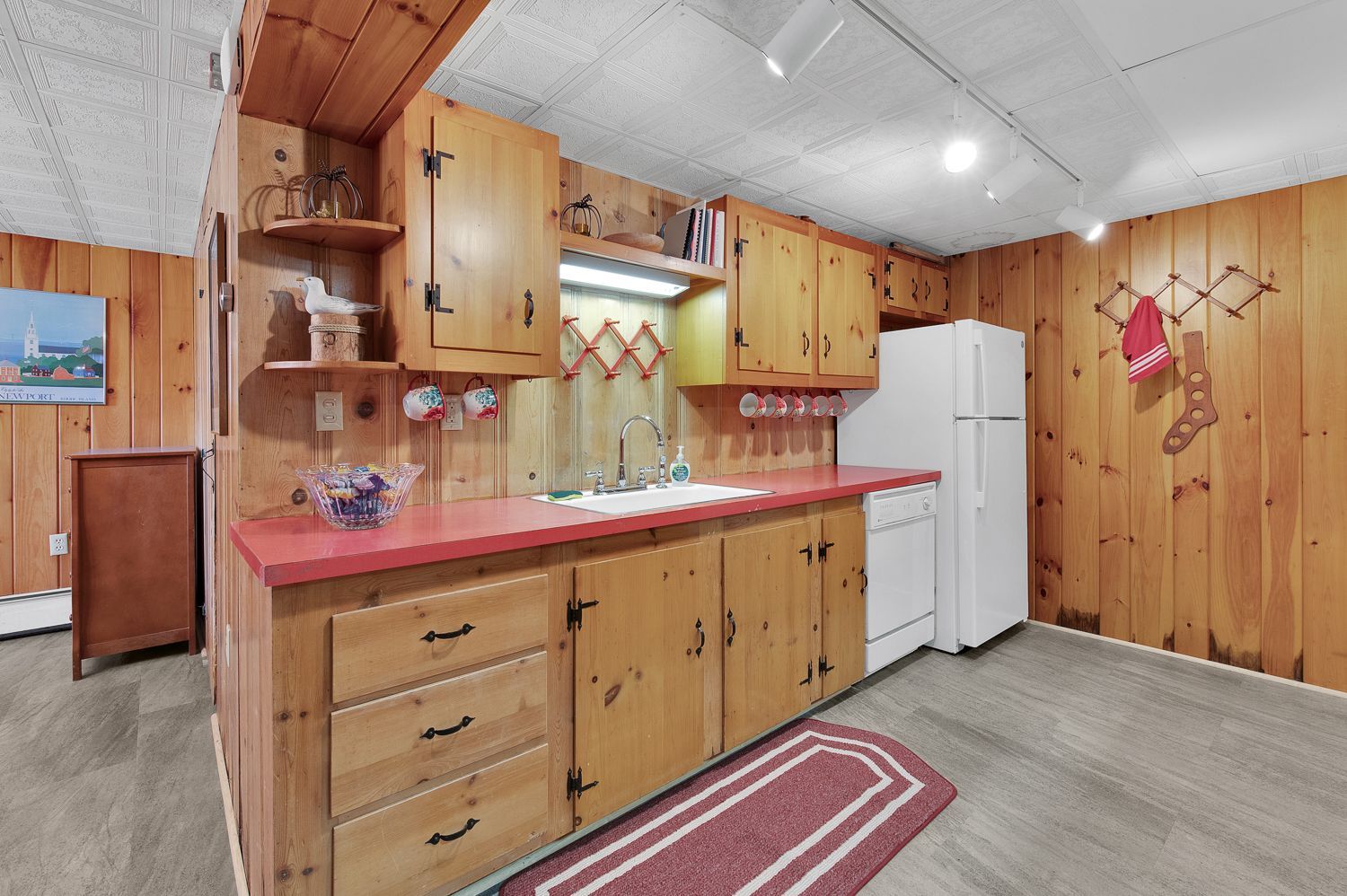 A kitchen with wooden cabinets and a white refrigerator