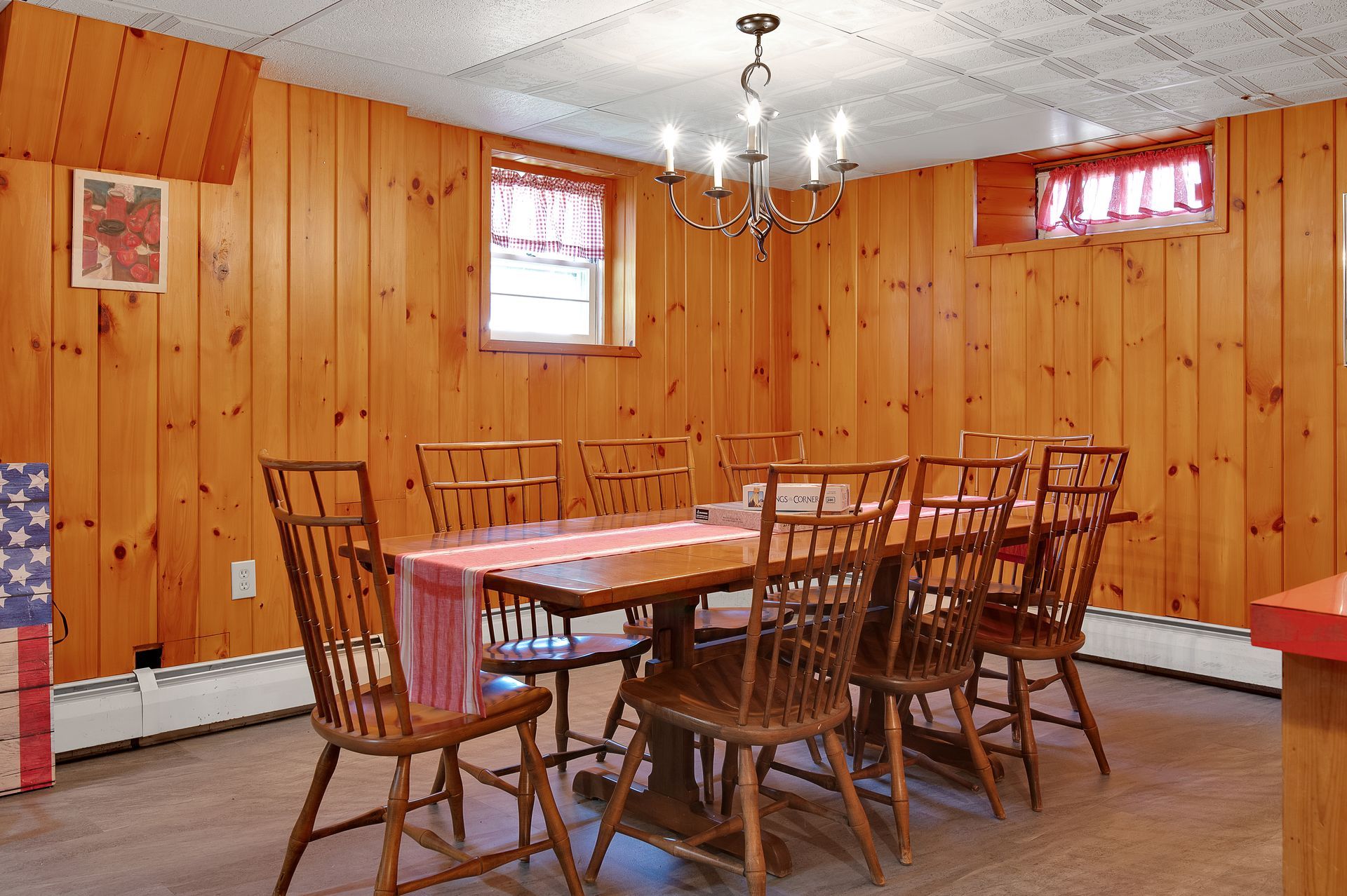 A dining room with a table and chairs and a chandelier